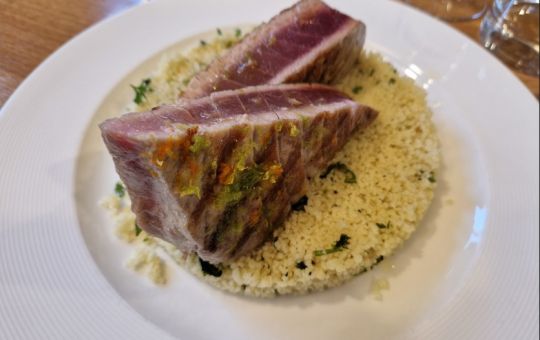 Thon rouge grillé et une semoule aux herbes fraîches, accompagnés d'une salade d'orange rafraîchissante et d'un fenouil croquant